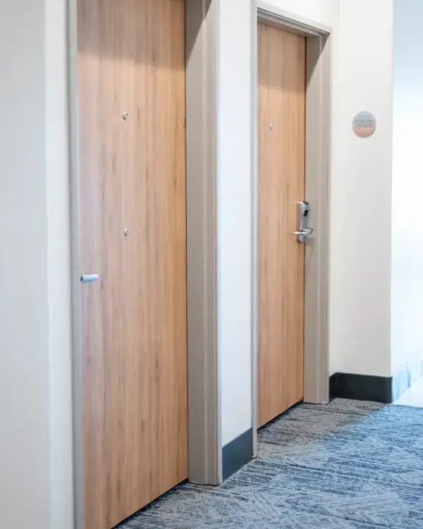 Hotel room doors finished in a warm wood grain film