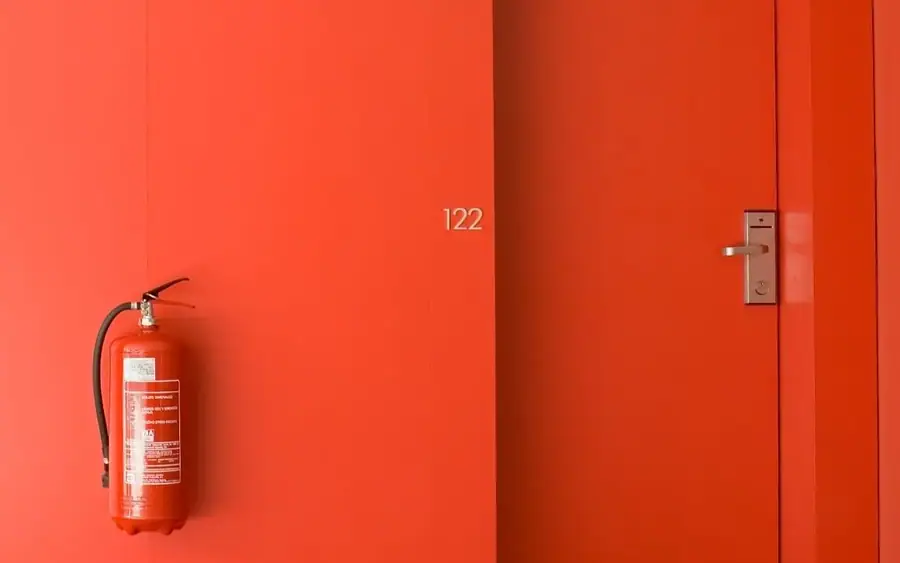 Hotel corridor with a numbered guest room door finished in S147 Candy Red film